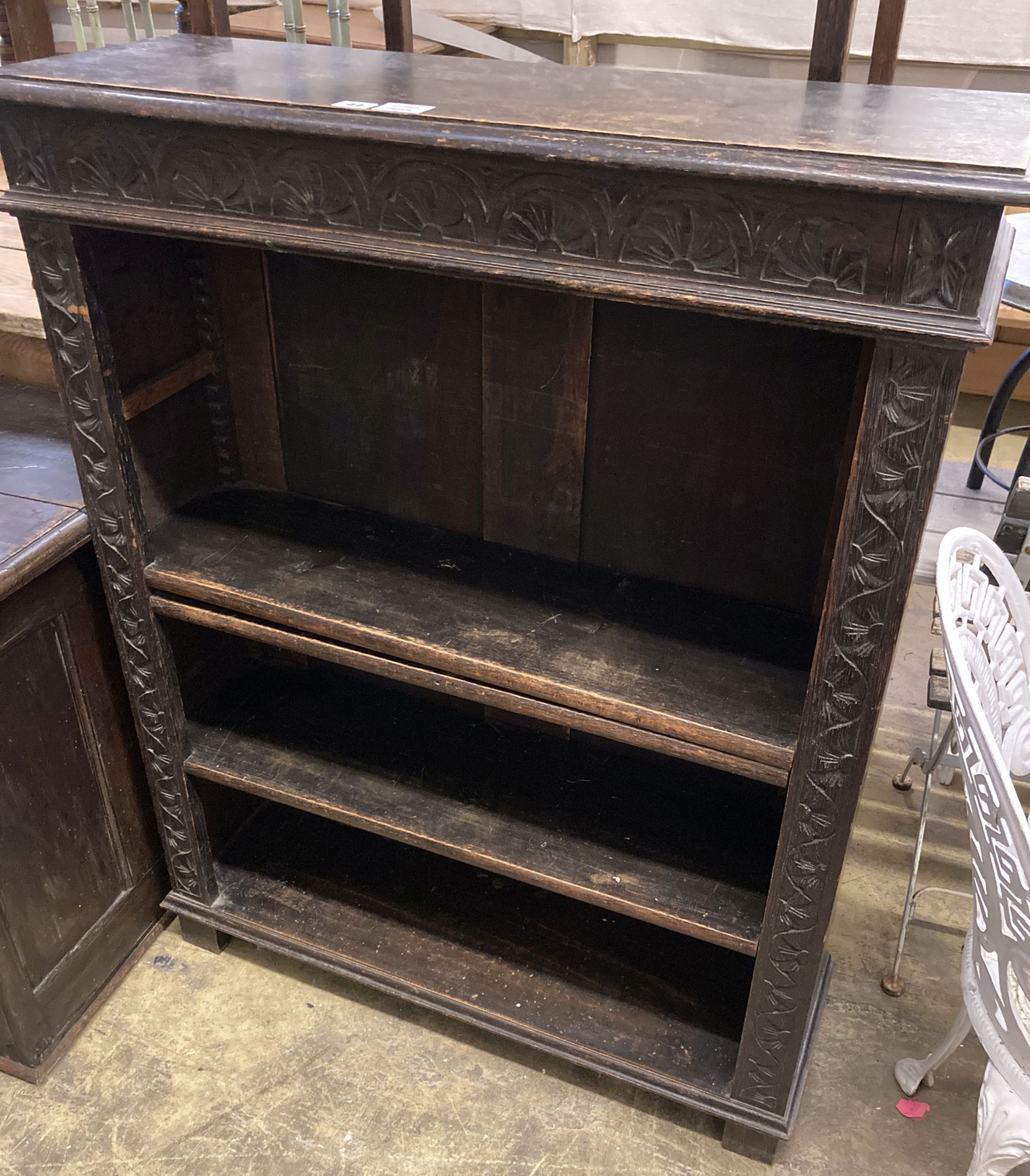 A late Victorian carved oak open bookcase, length 92cm, depth 31cm, height 115cm
